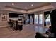 Open-concept kitchen features a breakfast bar, stainless steel appliances, and sliding glass doors leading to the patio at 143 S Gibbs Rd, Mooresville, NC 28117