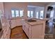 Open kitchen features granite countertops, stainless steel appliances, and abundant natural light at 143 S Gibbs Rd, Mooresville, NC 28117
