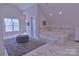 Spacious main bathroom featuring a soaking tub, glass shower, and white cabinets at 143 S Gibbs Rd, Mooresville, NC 28117
