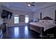 Main bedroom with hardwood floors, tray ceiling, four poster bed and large window at 143 S Gibbs Rd, Mooresville, NC 28117