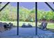 Inviting patio with outdoor seating, beautiful trees, and a view to the backyard at 143 S Gibbs Rd, Mooresville, NC 28117