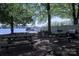 Picturesque picnic area with multiple tables, a grill, and a scenic view of the tranquil lake at 143 S Gibbs Rd, Mooresville, NC 28117