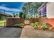 Charming brick-lined backyard featuring a decorative metal gate and lush plantings at 1473 12Th Street Nw Dr, Hickory, NC 28601