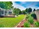 Lush backyard featuring a wooden deck, mature trees, and a well-manicured lawn at 1473 12Th Street Nw Dr, Hickory, NC 28601