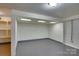 Unfinished basement with gray floor and built in storage shelves and recessed lighting at 1473 12Th Street Nw Dr, Hickory, NC 28601