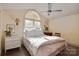 Bright bedroom features a large window, ceiling fan, and neutral décor creating a calming atmosphere at 1473 12Th Street Nw Dr, Hickory, NC 28601