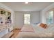 Bright bedroom with hardwood floors, natural light, and built-in shelving unit with decorative accents at 1473 12Th Street Nw Dr, Hickory, NC 28601