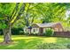 Inviting brick home with manicured lawn and mature trees creating a picturesque setting at 1473 12Th Street Nw Dr, Hickory, NC 28601