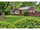 Charming brick home with mature landscaping, lush green lawn, and a welcoming front entrance at 1473 12Th Street Nw Dr, Hickory, NC 28601