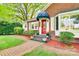 Charming brick home featuring a red front door with decorative glass, red mulch beds and a brick walkway at 1473 12Th Street Nw Dr, Hickory, NC 28601