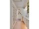 Hallway to bathroom with double french doors, tiled floor and sink with cabinets at 1473 12Th Street Nw Dr, Hickory, NC 28601