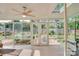 Inviting sunroom featuring tile flooring, skylight, and serene views of the beautifully landscaped backyard at 1473 12Th Street Nw Dr, Hickory, NC 28601