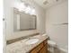 Bathroom featuring granite countertops, a single sink, brushed nickel hardware, and modern lighting at 16718 Hampton Crossing Dr, Huntersville, NC 28078