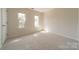 A simple, carpeted bedroom with two windows allowing ample natural light at 16718 Hampton Crossing Dr, Huntersville, NC 28078