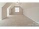 A large, carpeted bonus room with dormer windows at 16718 Hampton Crossing Dr, Huntersville, NC 28078