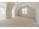 A large, carpeted bonus room with dormer windows at 16718 Hampton Crossing Dr, Huntersville, NC 28078