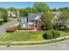 Charming two-story home with a well-manicured lawn and blooming flowers, showcasing curb appeal in a residential neighborhood at 16718 Hampton Crossing Dr, Huntersville, NC 28078