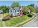 Beautiful two-story home with a well-maintained lawn, mature trees, and colorful landscaping, enhancing its curb appeal at 16718 Hampton Crossing Dr, Huntersville, NC 28078