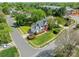 Beautiful home featuring a manicured front lawn with mature trees, colorful landscaping, and a charming white picket fence at 16718 Hampton Crossing Dr, Huntersville, NC 28078