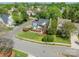Beautiful home showcasing a well-maintained lawn, mature trees, vibrant landscaping, and a classic white picket fence at 16718 Hampton Crossing Dr, Huntersville, NC 28078