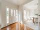Inviting foyer with hardwood floors, a glass front door, and a view into a dining area filled with natural light at 16718 Hampton Crossing Dr, Huntersville, NC 28078