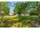 Lush front lawn framed by mature trees and white picket fencing, enhancing the curb appeal of this charming home at 16718 Hampton Crossing Dr, Huntersville, NC 28078