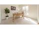 Bright home office with a large window, desk, and decorative plants, offering a comfortable and functional workspace at 16718 Hampton Crossing Dr, Huntersville, NC 28078
