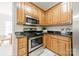 Kitchen featuring stainless steel appliances, granite countertops, and wooden cabinetry at 16718 Hampton Crossing Dr, Huntersville, NC 28078