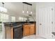 Well-equipped kitchen with stainless steel dishwasher and dark countertop at 16718 Hampton Crossing Dr, Huntersville, NC 28078