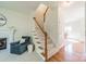 A charming living room with a cozy armchair, fireplace, and staircase at 16718 Hampton Crossing Dr, Huntersville, NC 28078