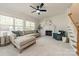 Spacious living room with a fireplace, neutral sofa, and bright windows, creating a cozy and inviting atmosphere at 16718 Hampton Crossing Dr, Huntersville, NC 28078