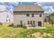 A fully fenced backyard has a built in BBQ, green grass and a pet in the area at 17712 Yarwill Ct, Charlotte, NC 28278