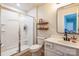 Bright bathroom features a glass shower, floating shelves, white cabinets and an oval sink at 17712 Yarwill Ct, Charlotte, NC 28278