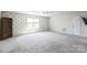Bedroom with carpet, a large window, and a bookshelf at 17712 Yarwill Ct, Charlotte, NC 28278