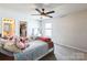 Comfortable bedroom with a ceiling fan, natural light, walk-in closet, and bathroom access at 17712 Yarwill Ct, Charlotte, NC 28278