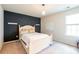 Bright bedroom featuring a queen bed, a blue accent wall, and natural light from a window at 17712 Yarwill Ct, Charlotte, NC 28278