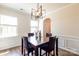 Dining room with hardwood floors, wainscoting detail, and modern chandelier at 17712 Yarwill Ct, Charlotte, NC 28278