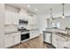 Bright kitchen features white cabinets, stainless steel appliances, and granite countertops at 17712 Yarwill Ct, Charlotte, NC 28278