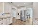 Bright kitchen features white cabinets, stainless steel appliances, granite countertops and tile backsplash at 17712 Yarwill Ct, Charlotte, NC 28278