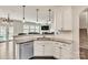 Kitchen with white cabinets, granite countertops, stainless steel dishwasher, and decorative pendant lighting at 17712 Yarwill Ct, Charlotte, NC 28278