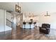 Spacious open floor plan with kitchen bar, hardwood floors, and decorative lighting at 17712 Yarwill Ct, Charlotte, NC 28278