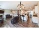 Open floorplan living room with hardwood floors, a fireplace, and bar seating in kitchen at 17712 Yarwill Ct, Charlotte, NC 28278