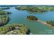 Scenic aerial view of a lakefront property with lush greenery and a connecting island at 179 Abington Ln, Troutman, NC 28166