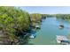Picturesque aerial view of a lakefront property featuring docks and covered boat slips at 179 Abington Ln, Troutman, NC 28166
