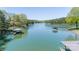 Aerial view of tranquil waterfront with multiple docks and boat shelters on a peaceful lake at 179 Abington Ln, Troutman, NC 28166