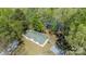 Aerial shot of a lakeside home surrounded by trees, featuring a spacious yard at 179 Abington Ln, Troutman, NC 28166