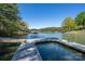 Lakefront property featuring a private dock and a gazebo perfect for outdoor relaxation and enjoying the serene water views at 179 Abington Ln, Troutman, NC 28166