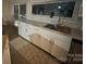 Bright kitchen featuring white cabinets, stone countertops, and a stainless steel sink at 179 Abington Ln, Troutman, NC 28166