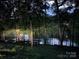 Scenic lake view with a private dock accessible through a serene wooded area at 179 Abington Ln, Troutman, NC 28166