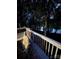 Cozy outdoor seating on a patio overlooking a calm lake surrounded by trees at 179 Abington Ln, Troutman, NC 28166